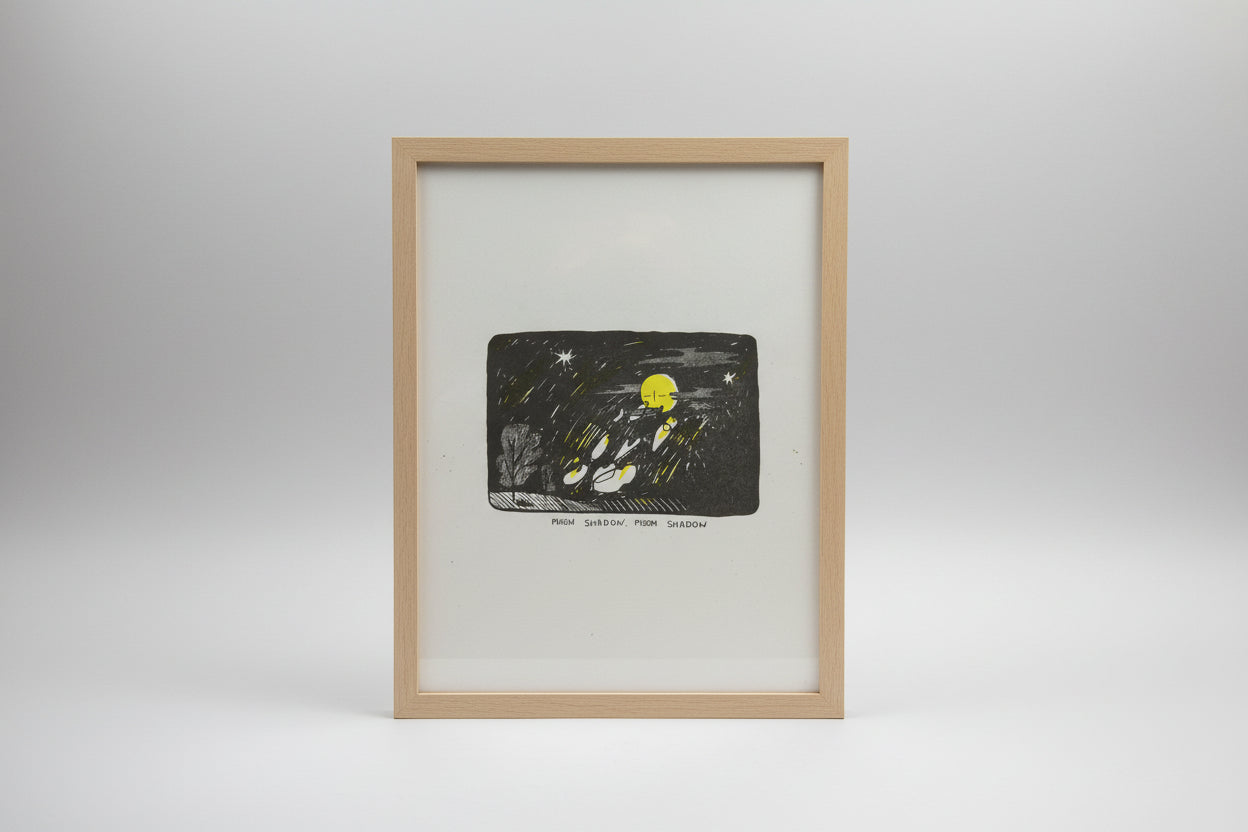 A square art print or illustration on white paper showing a dark night scene with a bright yellow moon, white stars, streaks of light, and a tree silhouette. Handwritten text below reads 'MOON SHADOW, MOON SHADOW'.